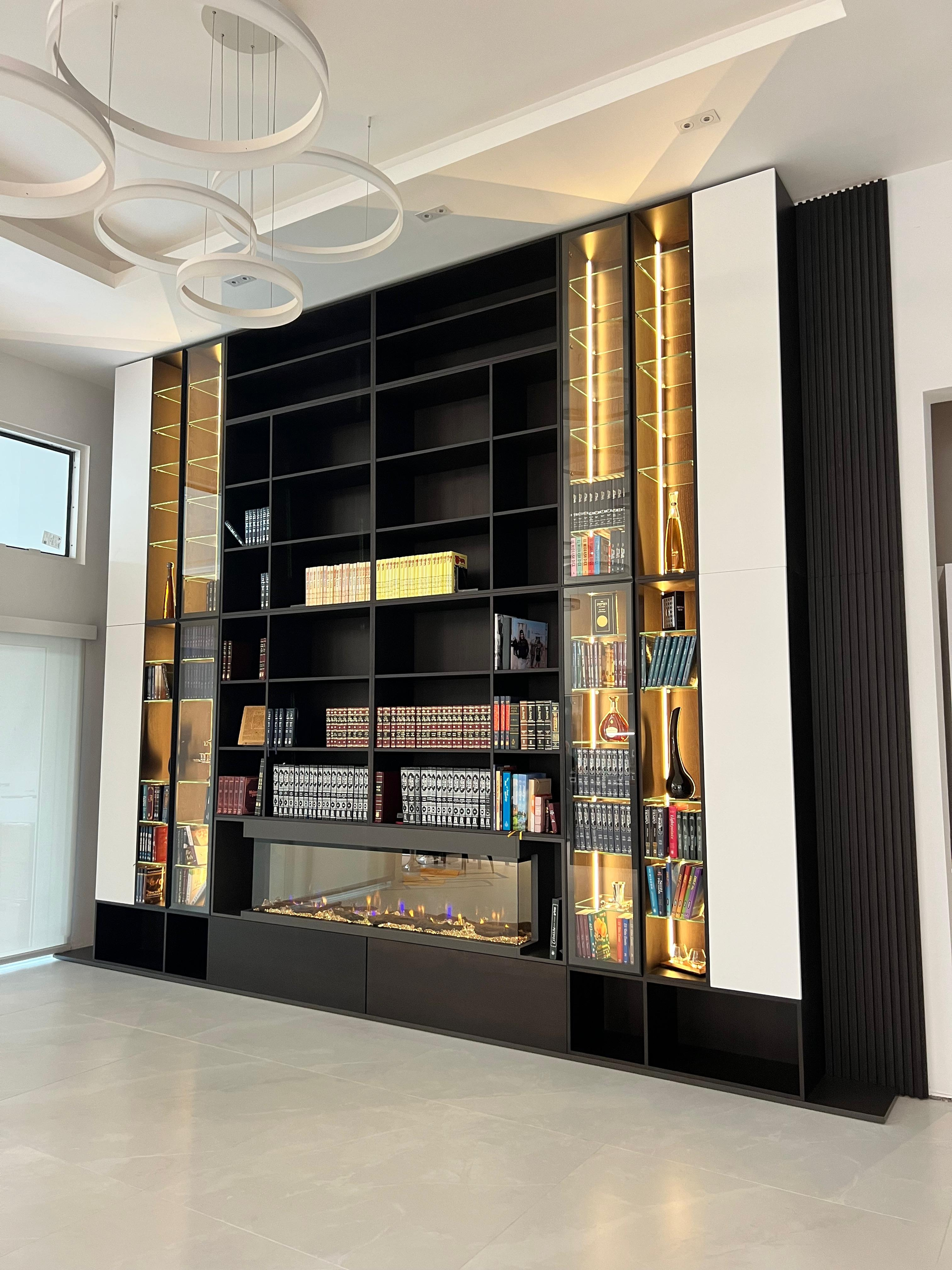 Built-in library wall with open shelving, styled with books and objects
