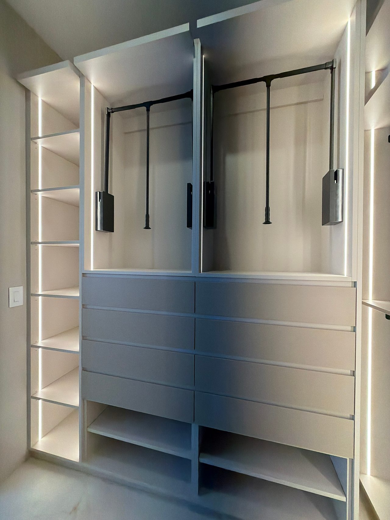 Closet elevation with two pull-down hanging rods above eight drawer fronts, an LED-lit shelf column at left and open shelves below